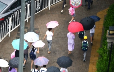 北京中小學學生雨中返校
