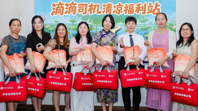 (图说:深圳女司机代表领取滴滴夏日清凉专属礼包及深圳市妇联、深圳妇儿基金会提供的女性出行暖心包。)