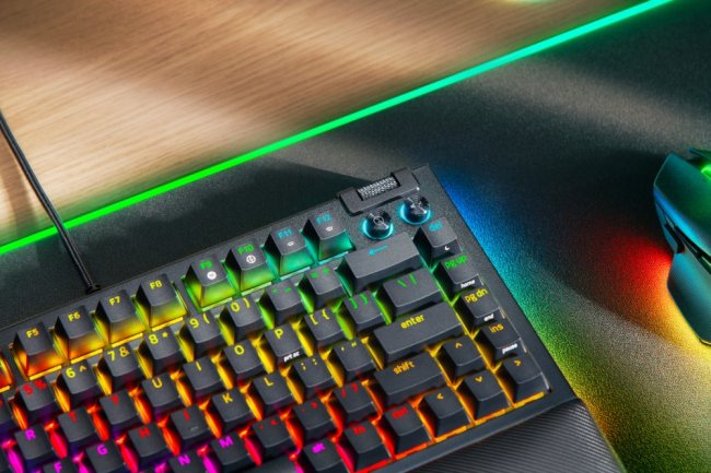 A keyboard with rainbow colored lights    Description automatically generated