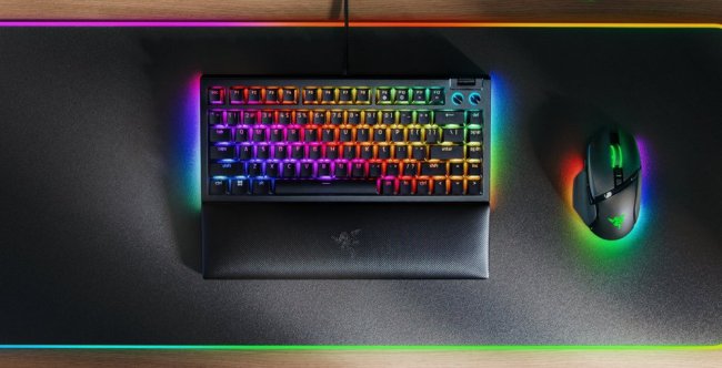 A rainbow colored keyboard on a mouse pad    Description automatically generated