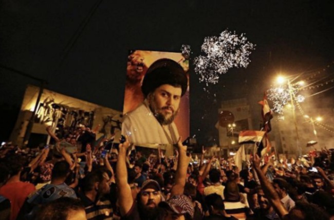 萨德尔的支持者们高举他的海报欢呼。