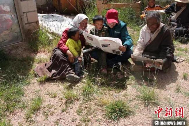 资料图为益西卓嘎与双湖县牧民一起读报。受访者供图