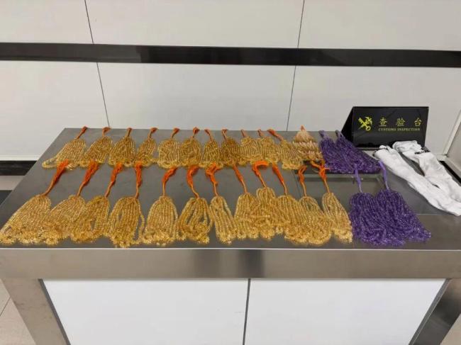 罗湖海关截获男子“水晶袜”套装 双腿绑藏28捆珠串